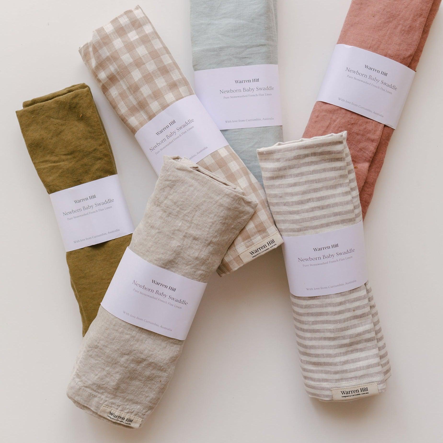 A set of Warren Hill French Linen Baby Swaddle napkins in natural color.