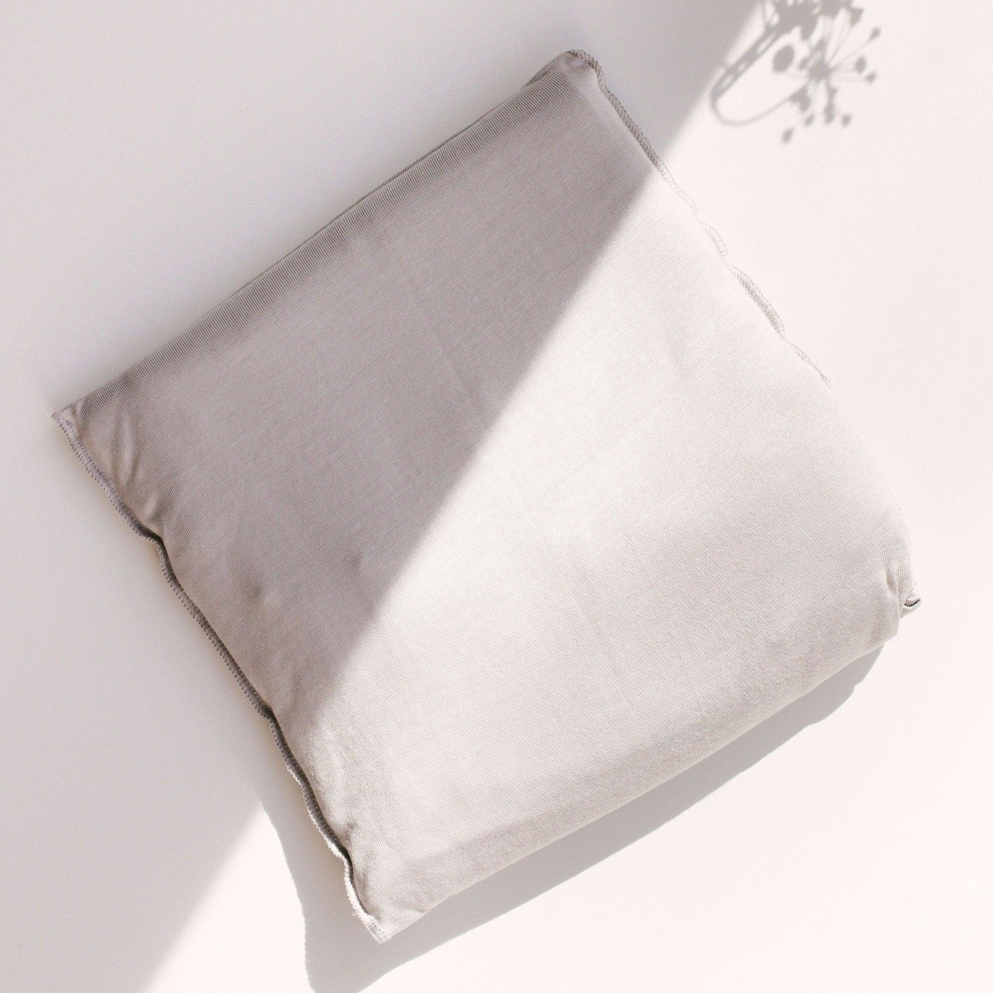 A white Asha Wrap on a surface from Chekoh.