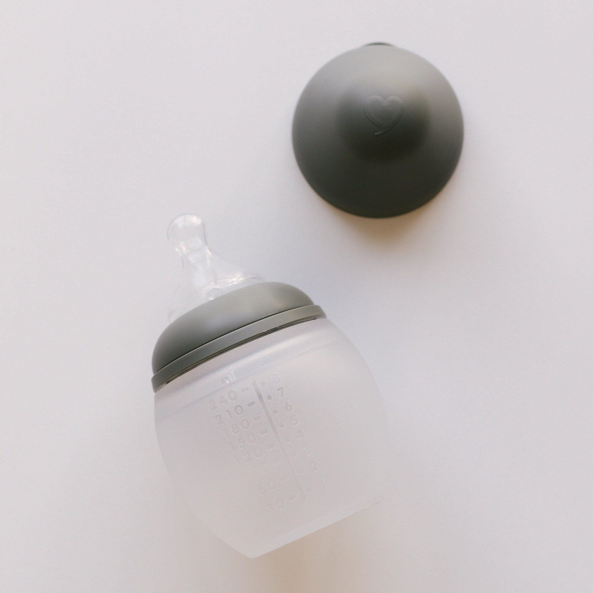A BibRond khaki bottle from Elhée France laying on a white surface.