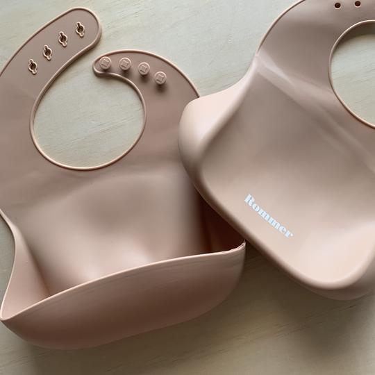 Rommer bibs are made from the softest silicone. They are both lightweight and durable. Rommer has updated the bib design to feature the reinforced button holes making them more resistant to tears.