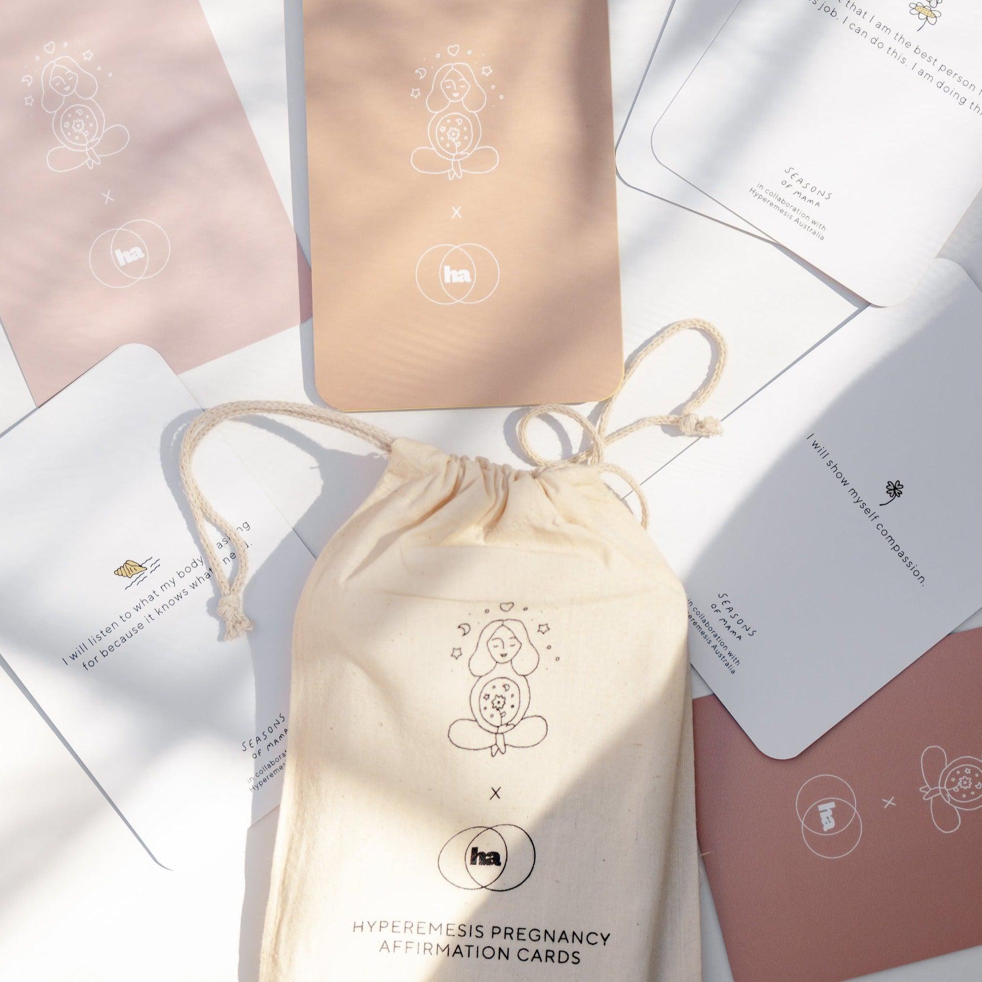 A branded calico bag featuring Hyperemesis Pregnancy Affirmation Cards by Seasons of Mama.