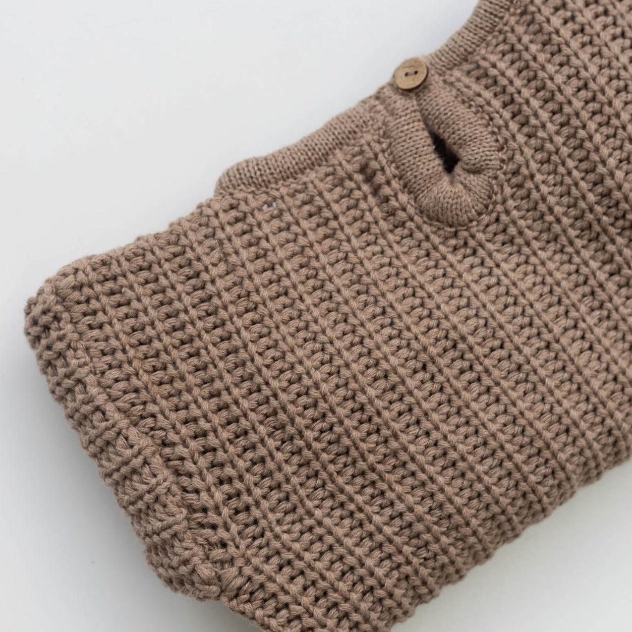 The Zoa knit is lovingly handmade using a loom which is a tool that is guided by the hand. 100% soft cotton, teardrop fastening at back with wood button. Good amount of stretch, considered true to size described as more ‘fitted’.
