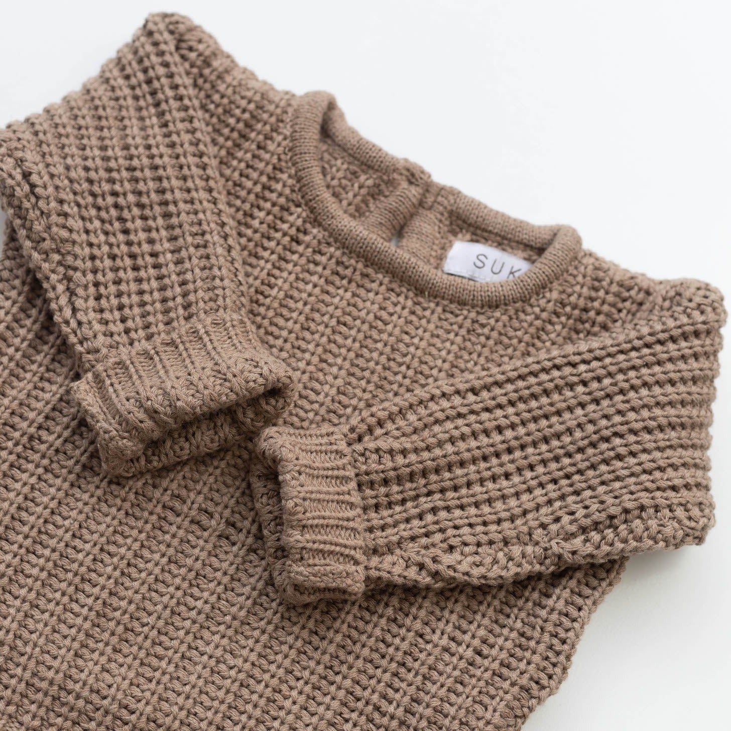 The Zoa knit is lovingly handmade using a loom which is a tool that is guided by the hand. 100% soft cotton, teardrop fastening at back with wood button. Good amount of stretch, considered true to size described as more ‘fitted’.