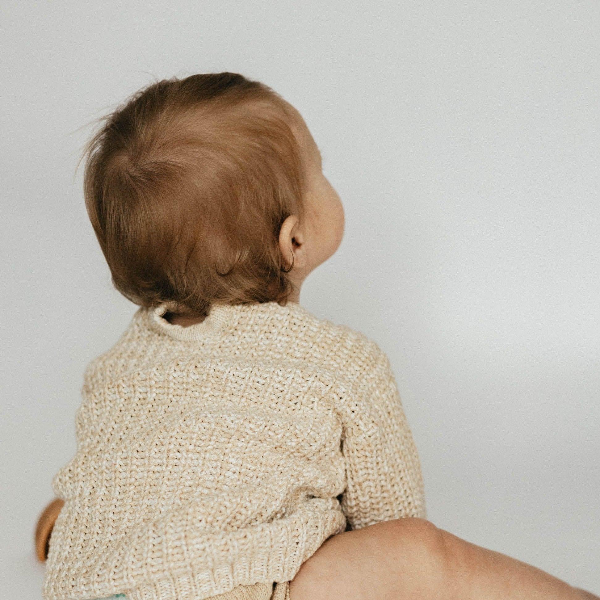 The Zoa knit is lovingly handmade using a loom which is a tool that is guided by the hand. 100% soft cotton, teardrop fastening at back with wood button. Good amount of stretch, considered true to size described as more ‘fitted’.