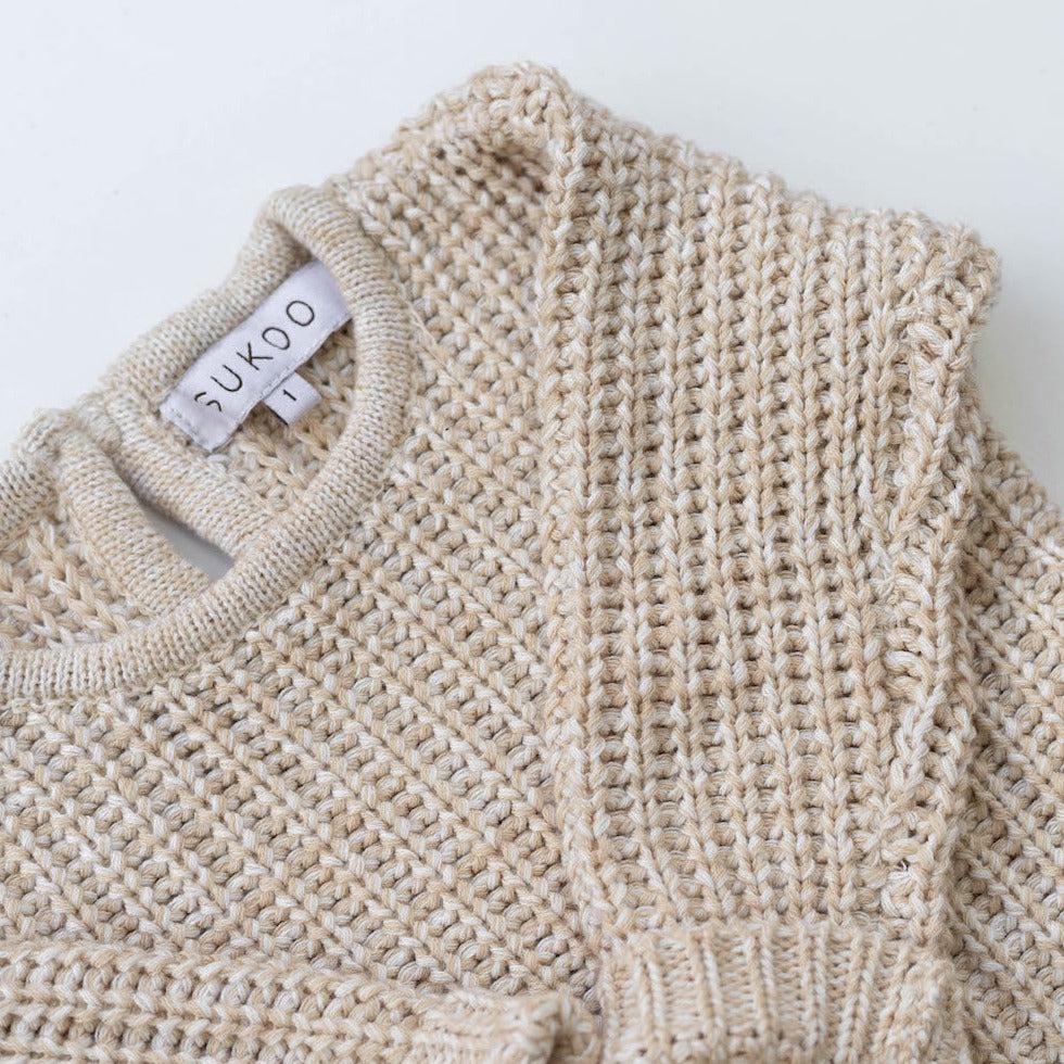 The Zoa knit is lovingly handmade using a loom which is a tool that is guided by the hand. 100% soft cotton, teardrop fastening at back with wood button. Good amount of stretch, considered true to size described as more ‘fitted’.