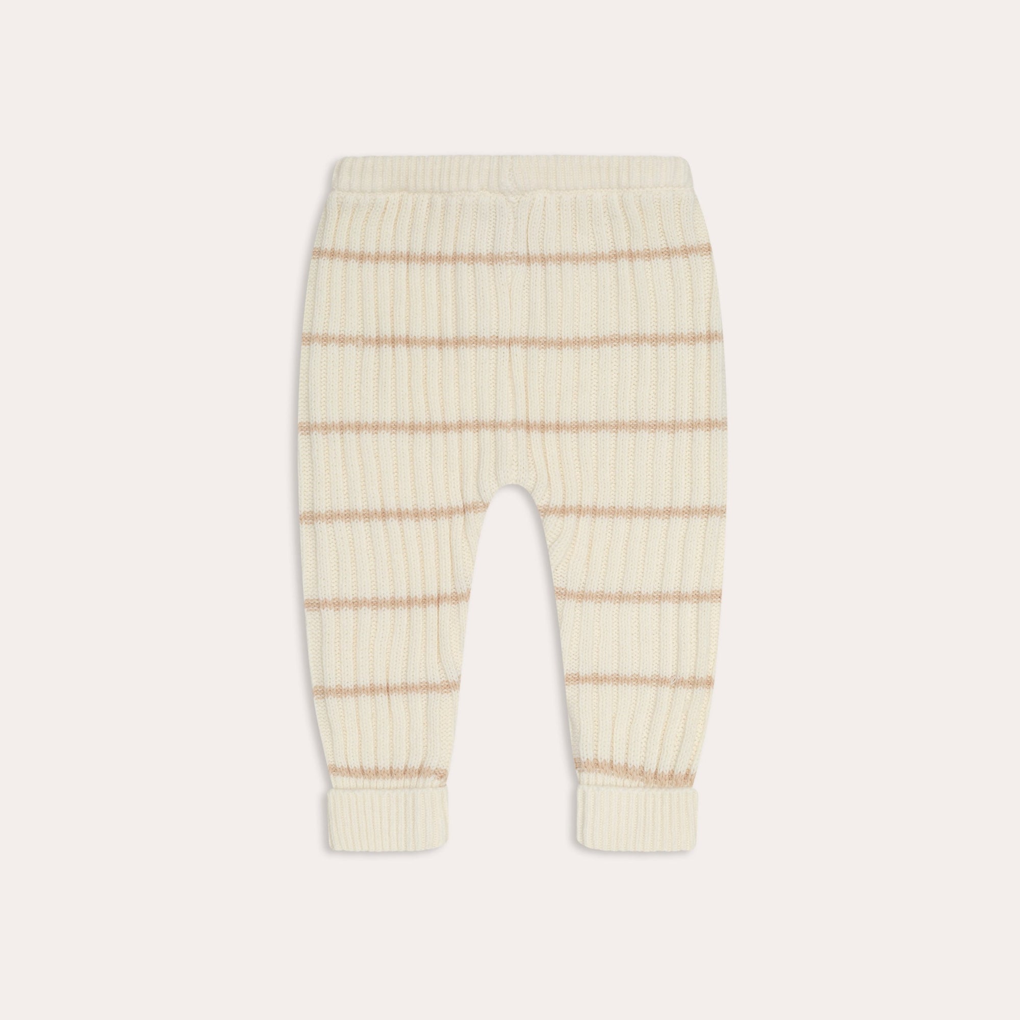 A pair of cream-colored knit pants with horizontal beige stripes, featuring a ribbed elastic waistband and folded cuffs, crafted from soft organic cotton. Product Name: illoura knit joey pants | sand stripe Brand Name: Illoura the Label.