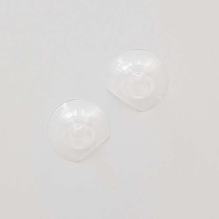 A pair of Haakaa Silicone Nipple Shields on a white surface.