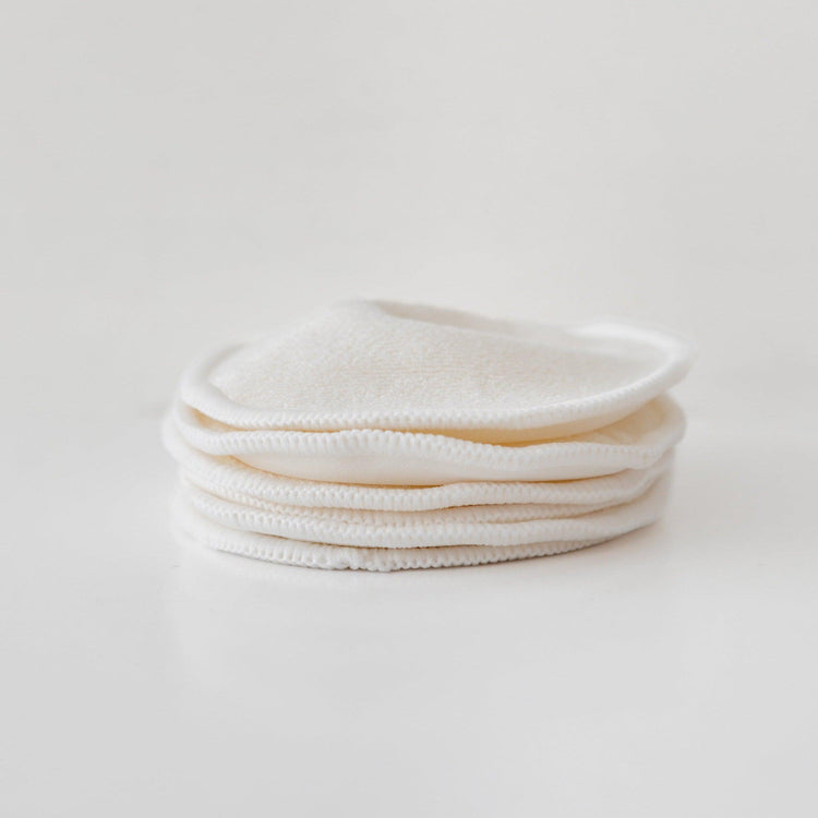 A stack of postpartum breast pads for nursing in Mammae bosom wearables showcased on a white surface.